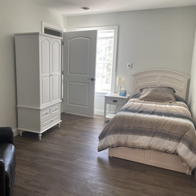 A well-furnished private resident room with natural light