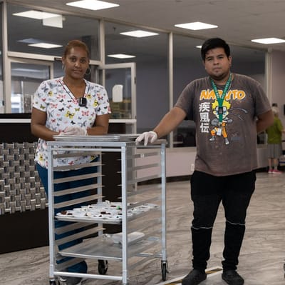 Staff preparing food in a facility interior