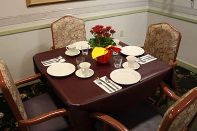 Table set for dining with flowers in a cozy interior
