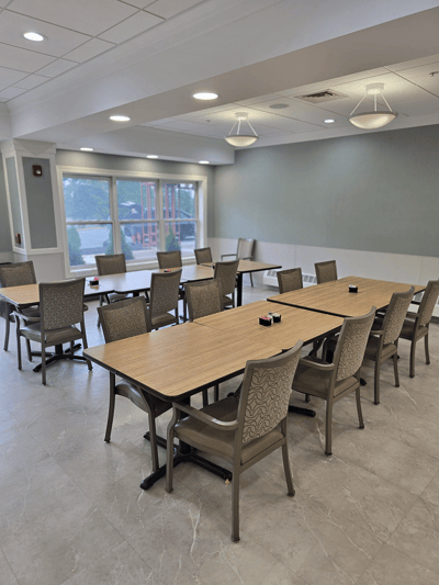 Bright dining area with tables and chairs set up