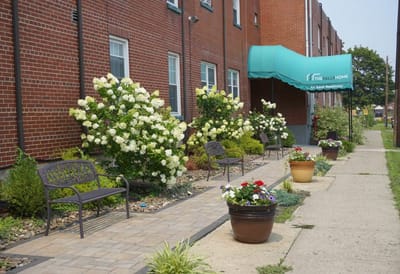 Outdoor seating area with blooming flowers and building entrance
