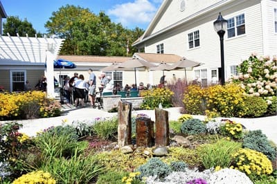 Residents and staff enjoying the outdoor space at Woodlawn Commons