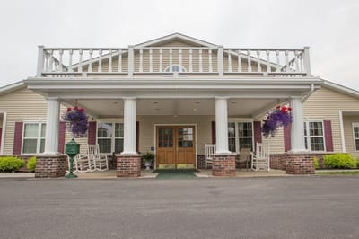Front entrance of The Terrace at Newark with rocking chairs