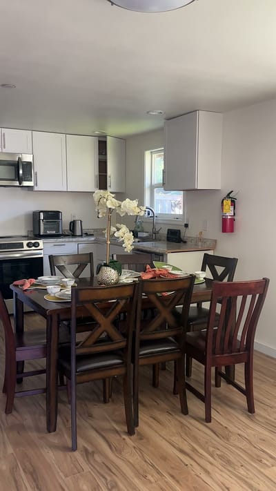 A dining area with a table set for a meal
