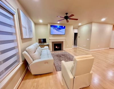 Cozy common area with white sofas and a fireplace