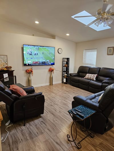 Cozy common area with sofas and a large TV