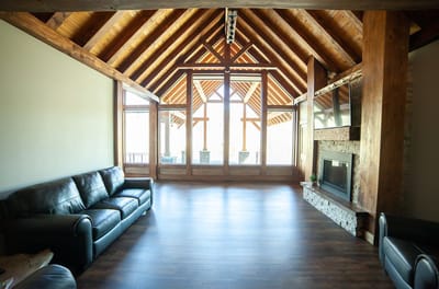 Interior view of a common area with wooden beams and a fireplace