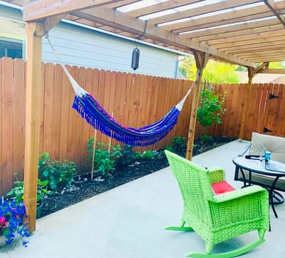 A cozy outdoor space with a hammock and seating