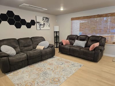 Comfortable lounge area with two sofas and decorative wall art