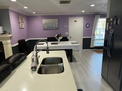 Interior view of a community dining area with purple walls