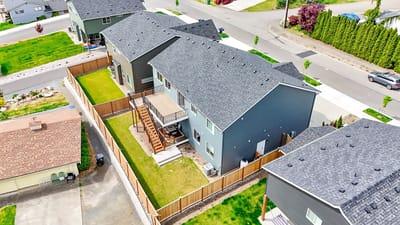 Aerial view of multiple residential buildings and green spaces