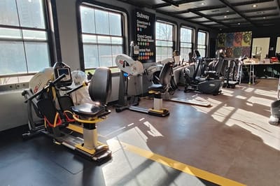 Fitness equipment in a well-lit exercise room