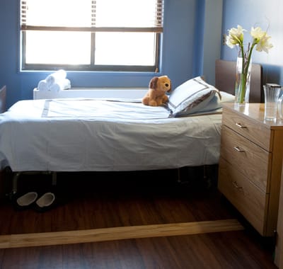Well-furnished private resident room with a teddy bear