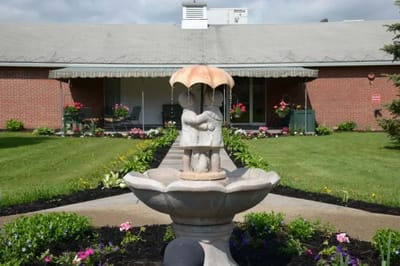 Outdoor fountain in a landscaped area at the facility