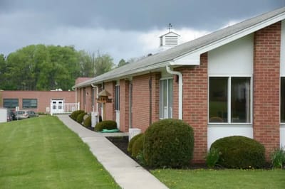 Exterior view of a senior living facility pathway and rooms