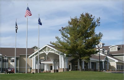 Exterior view of NYS Veterans Home with flags