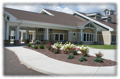 Exterior view of nursing home with landscaped entrance