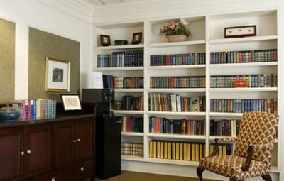 Cozy interior of a common area with bookshelves and a chair