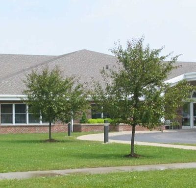 Exterior view of Father Baker Manor with trees