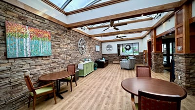 Bright, inviting common area with stone walls