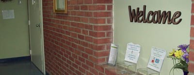 Interior hallway with a welcome sign and informational displays