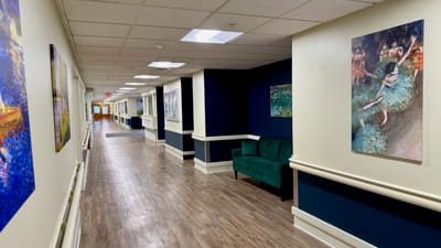 Interior hallway with art and seating area