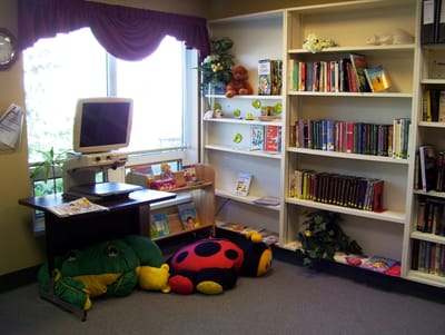 Cozy reading corner in a common area with books and cushions