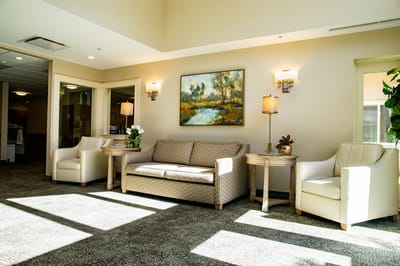Bright common area with comfortable seating and art