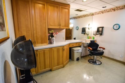 Hair salon area with styling chair and equipment