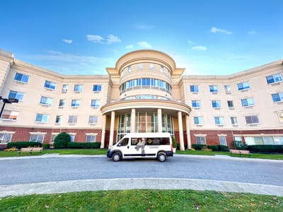 Exterior view of Fulton Commons Care Center with facility van