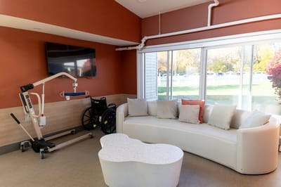 Bright common area with modern seating and a wheelchair