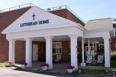 Exterior view of Lutheran Home entrance with flower pots