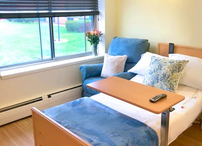 Cozy resident room with a chair and flowers