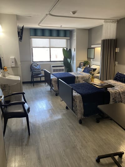 Private resident room with two beds and decor