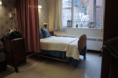 A cozy resident room with a bed and decorations