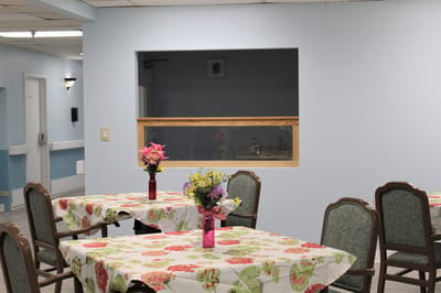Interior view of a dining area with floral tablecloths