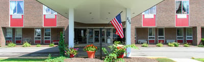Front entrance of a rehabilitation healthcare facility with flower pots