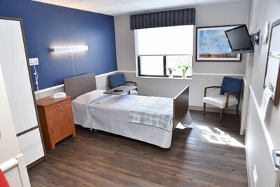 A well-furnished private resident room with natural light