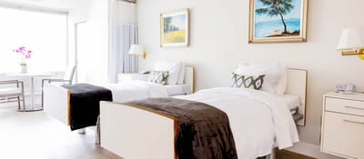 Bright and minimalist twin bedroom in a senior living facility