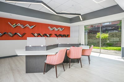 A modern common area with seating and bookshelves