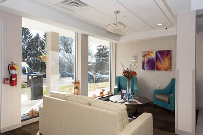 Bright common area with seating and large windows