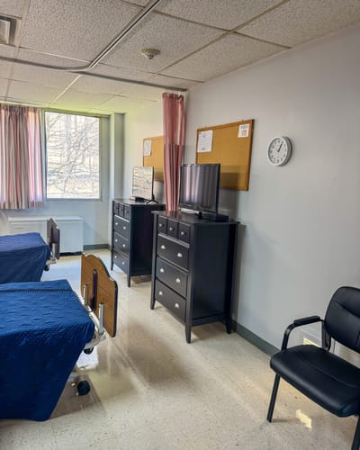 Private resident room with beds and furniture