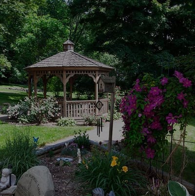 A peaceful outdoor garden with gazebo and flowers