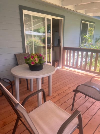 Outdoor seating area with flowers on a wooden deck