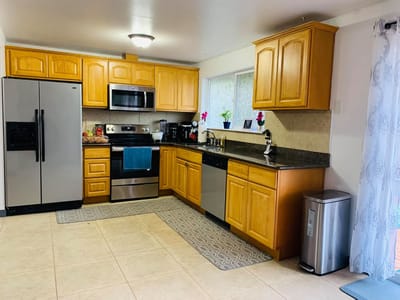 Bright kitchen area with wooden cabinets and appliances