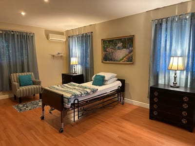 Bright private resident room with bed and furnishings