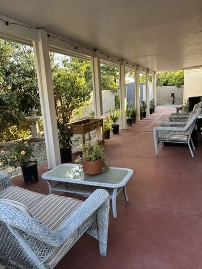 Covered outdoor seating area with plants