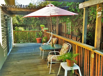 Outdoor patio area with seating and umbrella