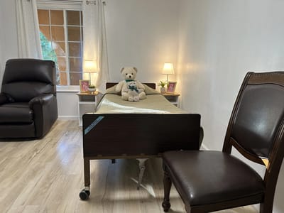 Cozy resident room with a teddy bear on the bed