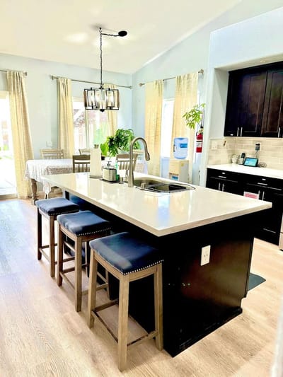 Bright kitchen area with seating and plants